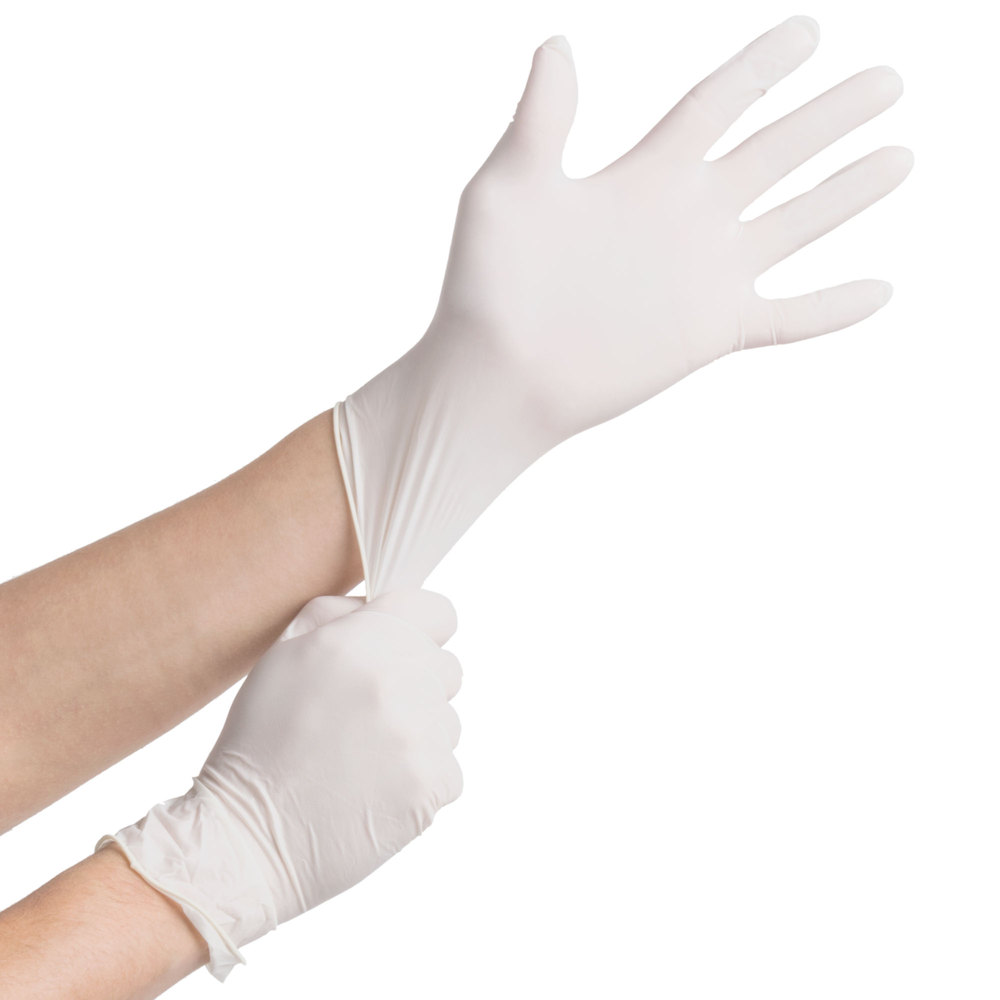 Healthcare professional putting on white gloves with both hands.