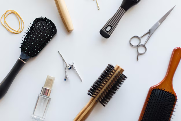 A professional flat lay of high-quality hair beauty supplies and salon tools, including various hairbrushes, scissors, clips, and styling products for retail stores.