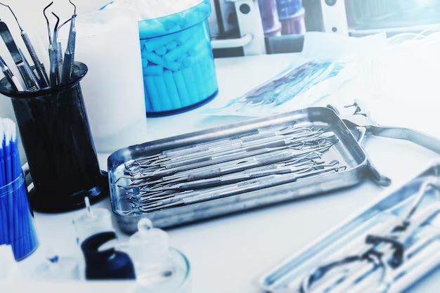 A close-up of sterile medical diagnostic instruments and hospital supplies, including forceps and probes in a tray, used by healthcare professionals for accurate patient testing and diagnosis