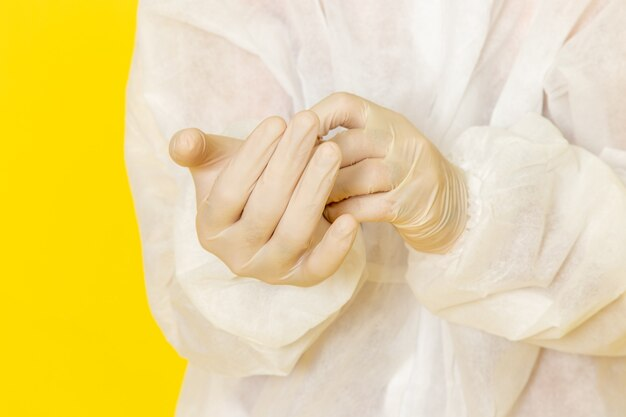 A surgeon in a sterile gown putting on Livingstone surgical latex gloves to ensure hygiene and precision during a medical procedure.