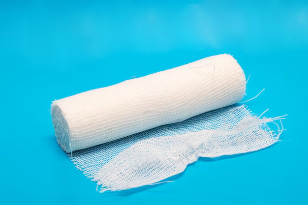 A roll of white Livingstone conforming cotton bandage on a blue background, designed for supporting injuries and holding dressings in place.
