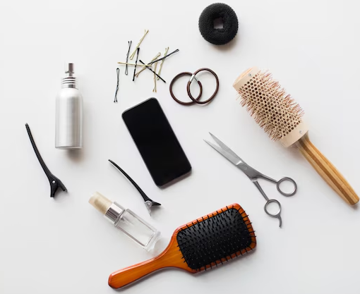 A professional collection of premium hair beauty supplies, including salon-grade hairbrushes, styling scissors, and hair clips, laid out for retail store sourcing.