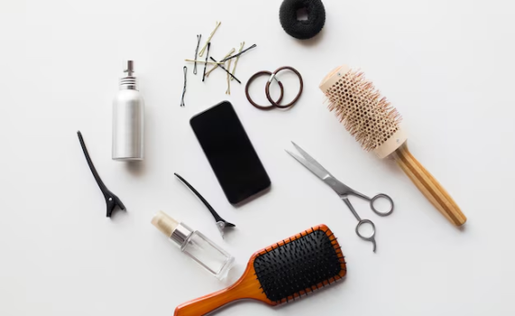 A professional collection of premium hair beauty supplies, including salon-grade hairbrushes, styling scissors, and hair clips, laid out for retail store sourcing.