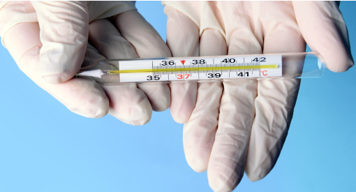 Laboratory technician holding a precision thermometer for temperature measurement, scientific research, quality control, and testing applications.