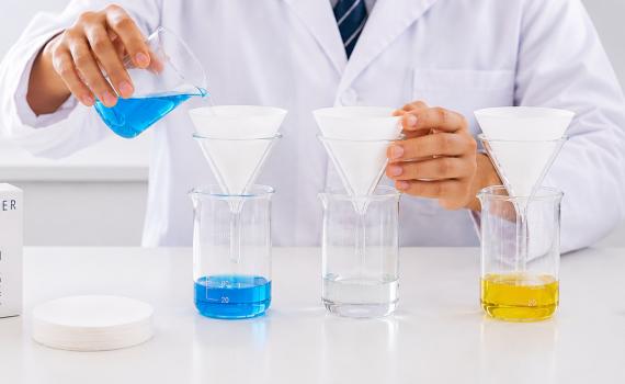Student using filter paper in a school science laboratory filtration experiment