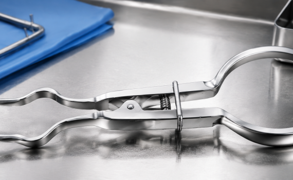 Rubber dam forceps arranged with dental isolation equipment in a clinical setting