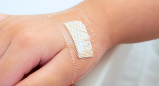 Child's hand with wound dressing