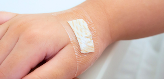 Child's hand with wound dressing