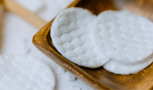 Round cotton pads on wooden tray