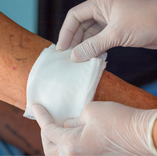 Clinician placing dressing on wounded arm