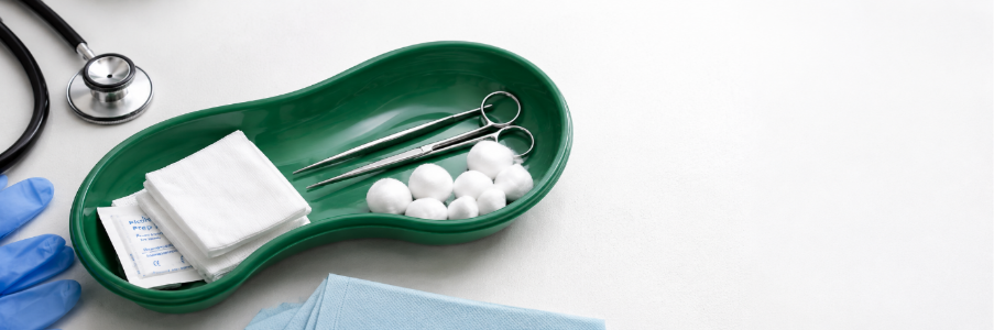 Kidney dish tray arranged with wound care supplies and medical instruments