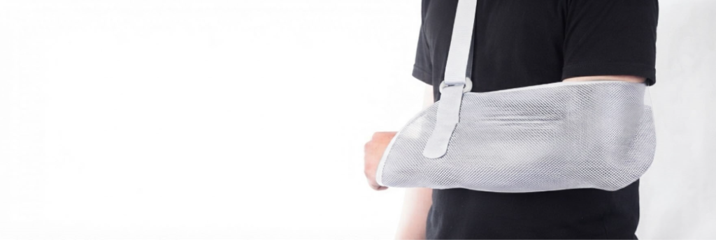 Person wearing an adjustable arm sling