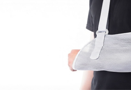 Person wearing an adjustable arm sling