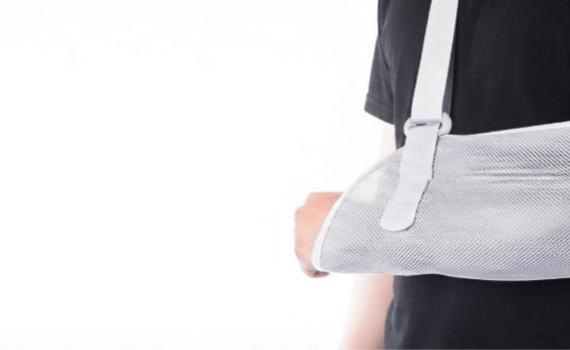 Person wearing an adjustable arm sling