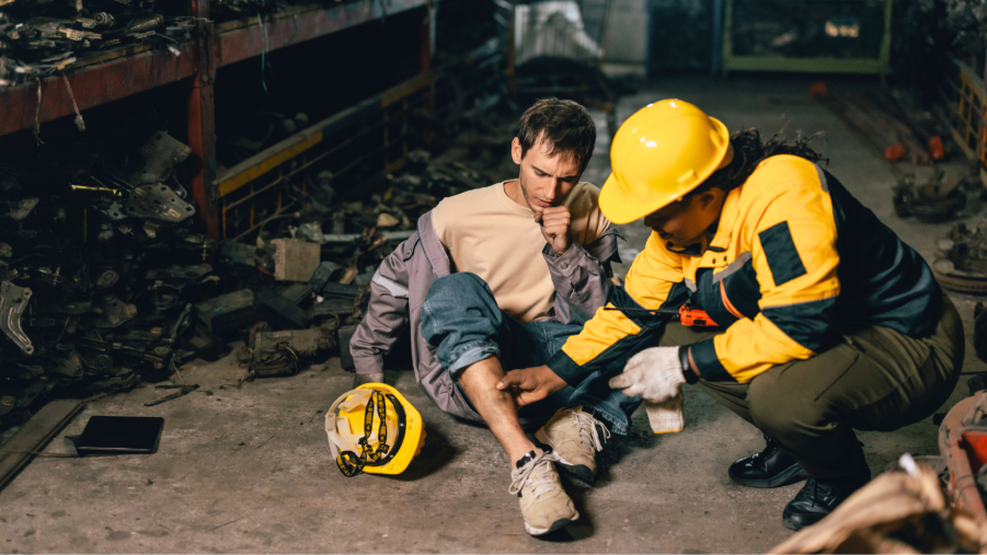 First aider aiding on man's right leg