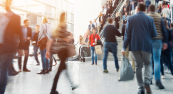 people moving through a busy public indoor space
