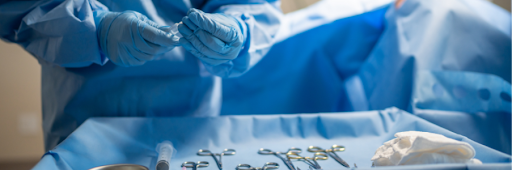 Surgeon selecting straight and curved Potts-Smith dissecting forceps from a sterile surgical instrument tray before an operation